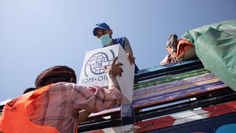 IOM staff distribute relief items